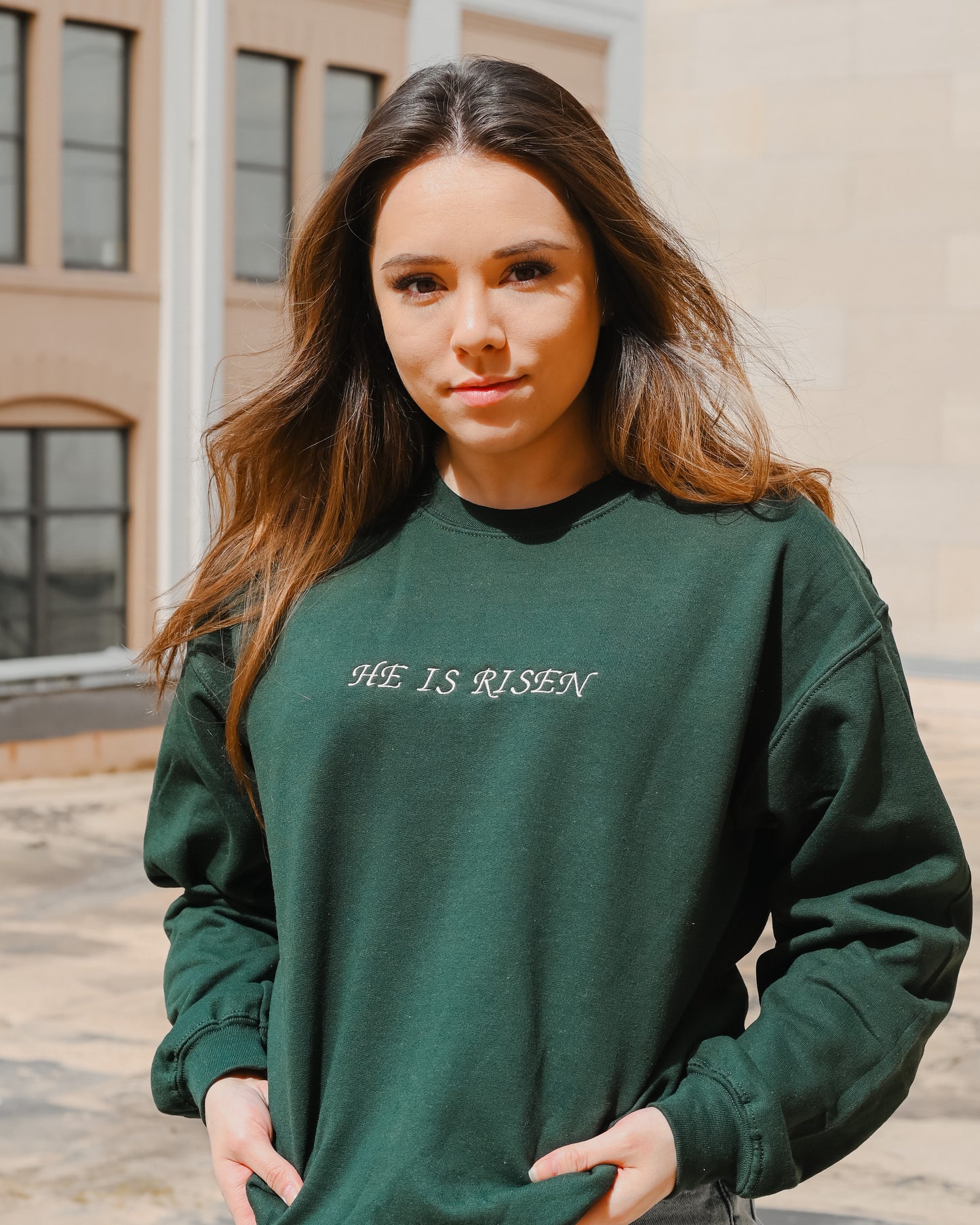Forest green embroidered “HE IS RISEN” crewneck