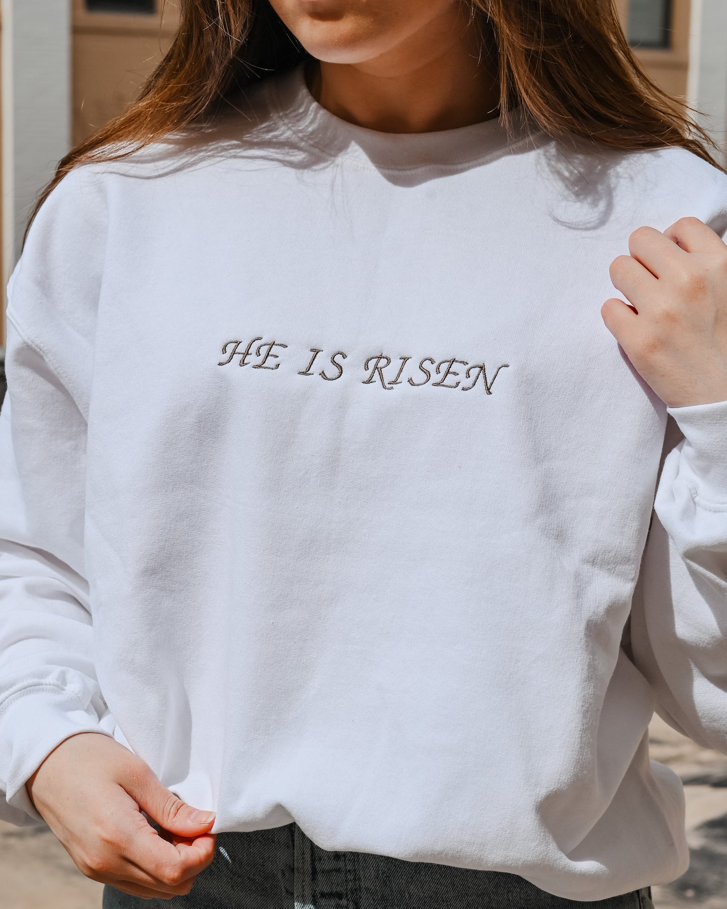 White embroidered “HE IS RISEN” crewneck
